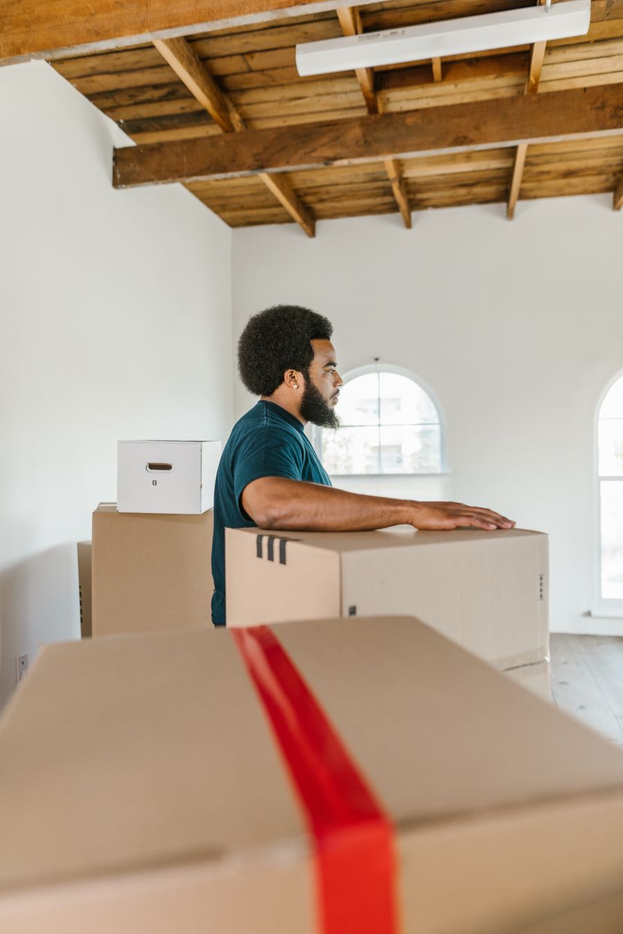 A worker moving cartons inside a room