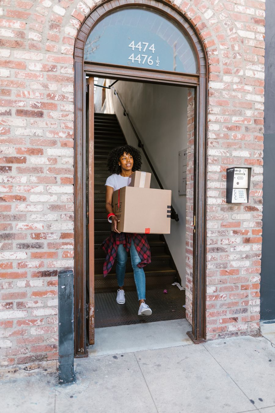 Cartons being carried out of an apartment building